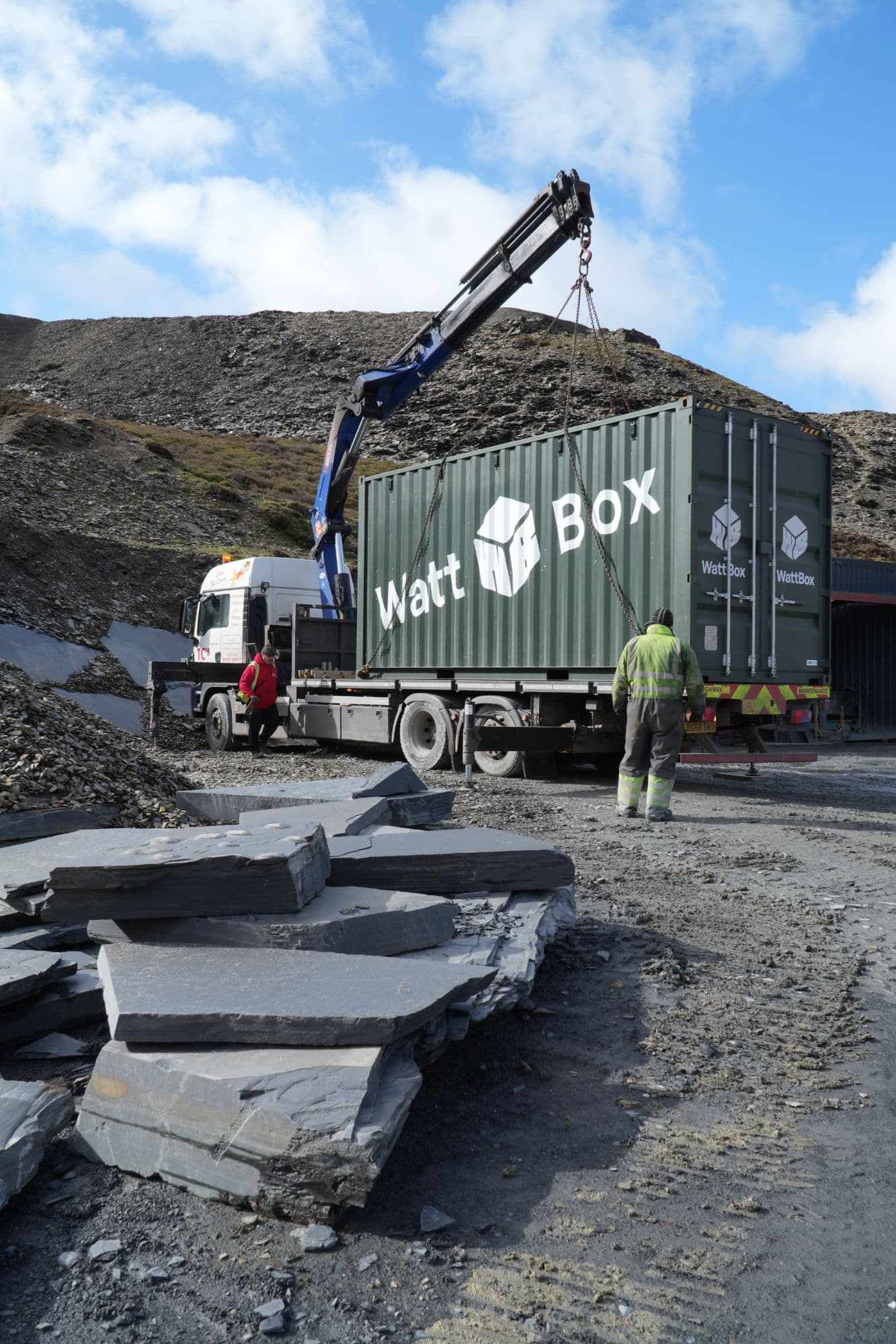 A WattBox container being craned into a slate quarry